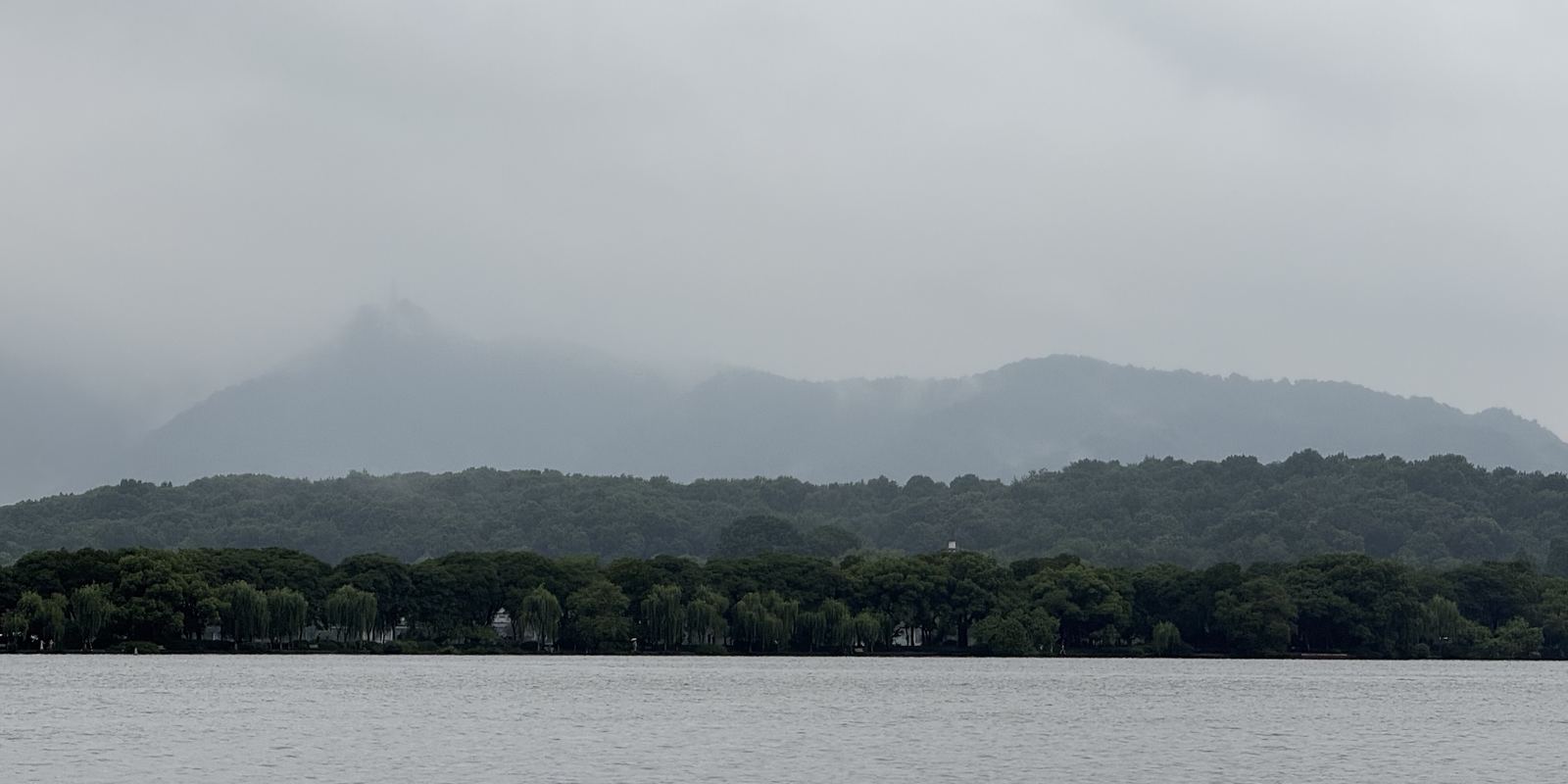 West Lake under low cloud, with the hills beyond