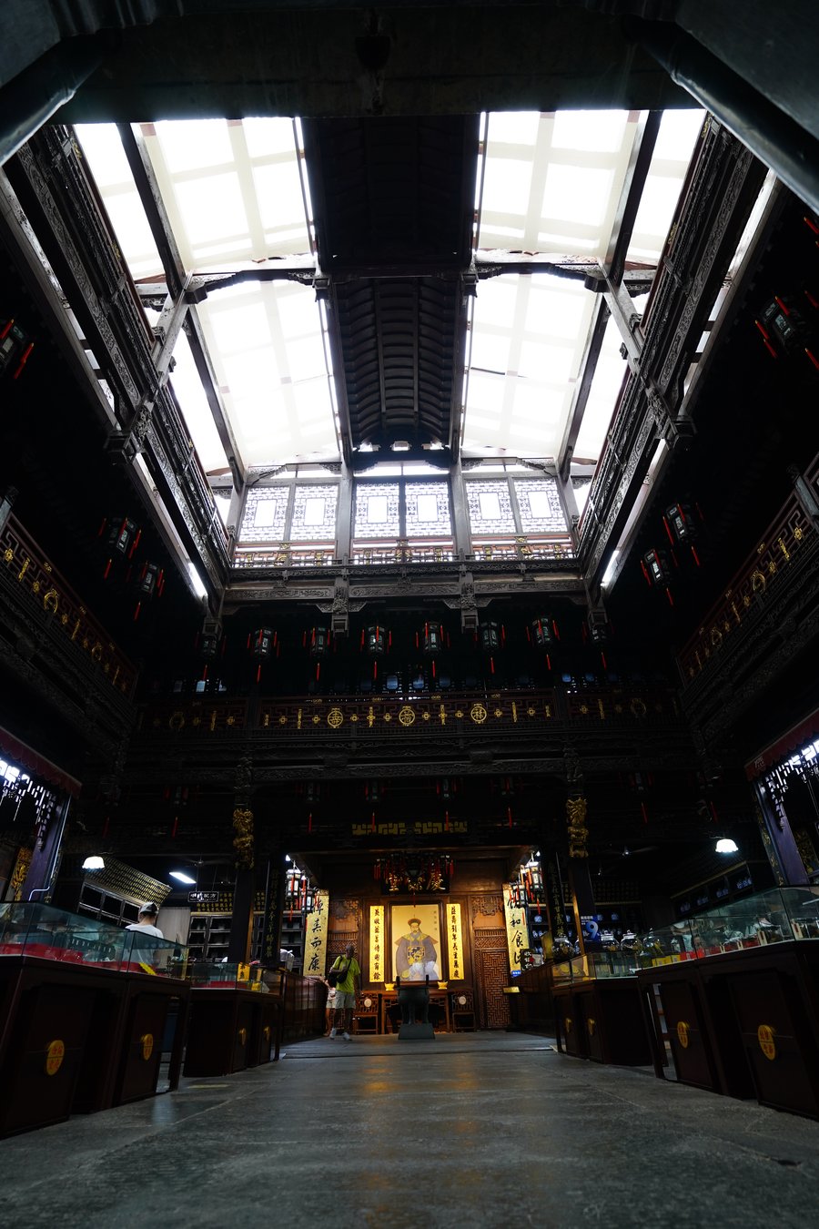 The dim, ornate interior hall of a historic Qinghefang building