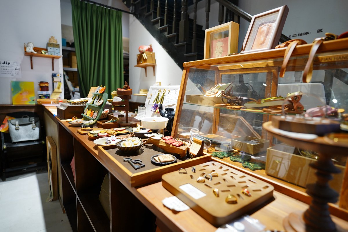 A handicraft counter in Qinghefang displaying small handmade wooden and decorative objects