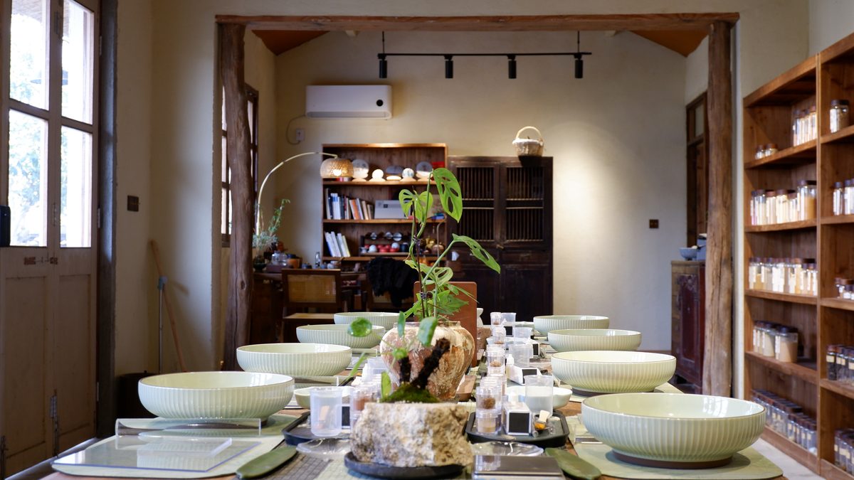 The workshop interior with bookshelves and a long set table
