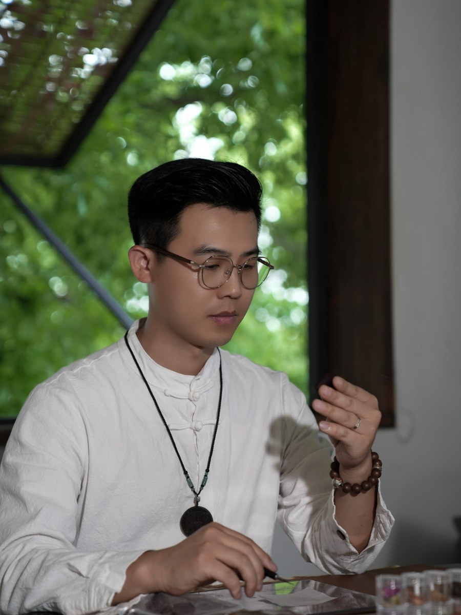 Mr Yang, the incense maker, working with aromatic materials at his studio table