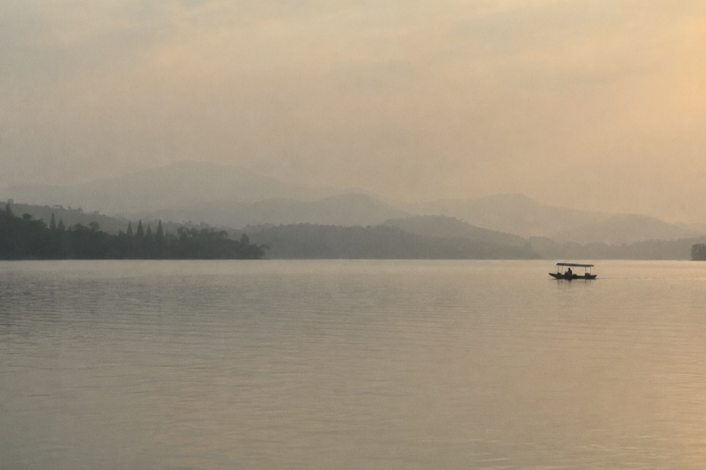West Lake at dusk with boats on still water