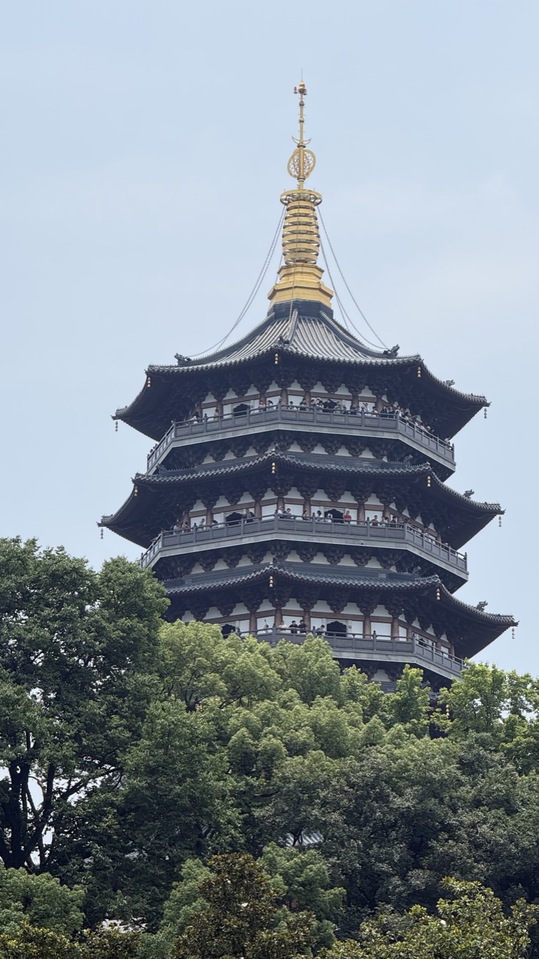 Leifeng Pagoda rising above garden trees