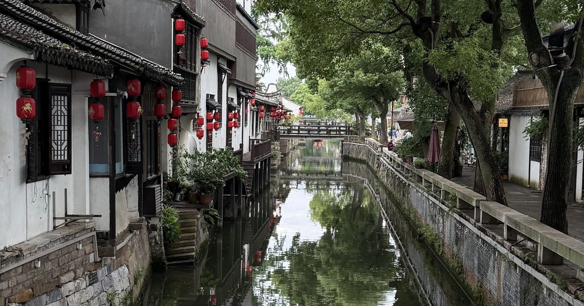 A tree-lined street and traditional shopfront in Qinghefang, Hangzhou